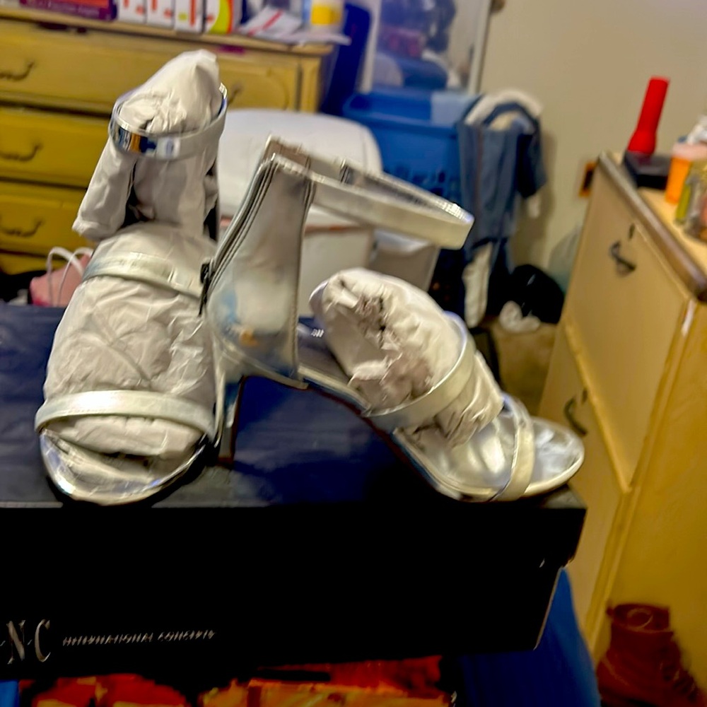 3 1/2 inch strappy heels. They are Silver. Shoes are brand new.